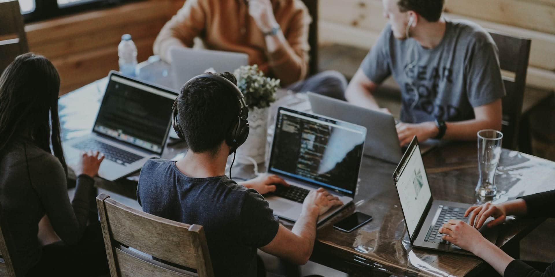 Colleagues working together on laptops at an office table